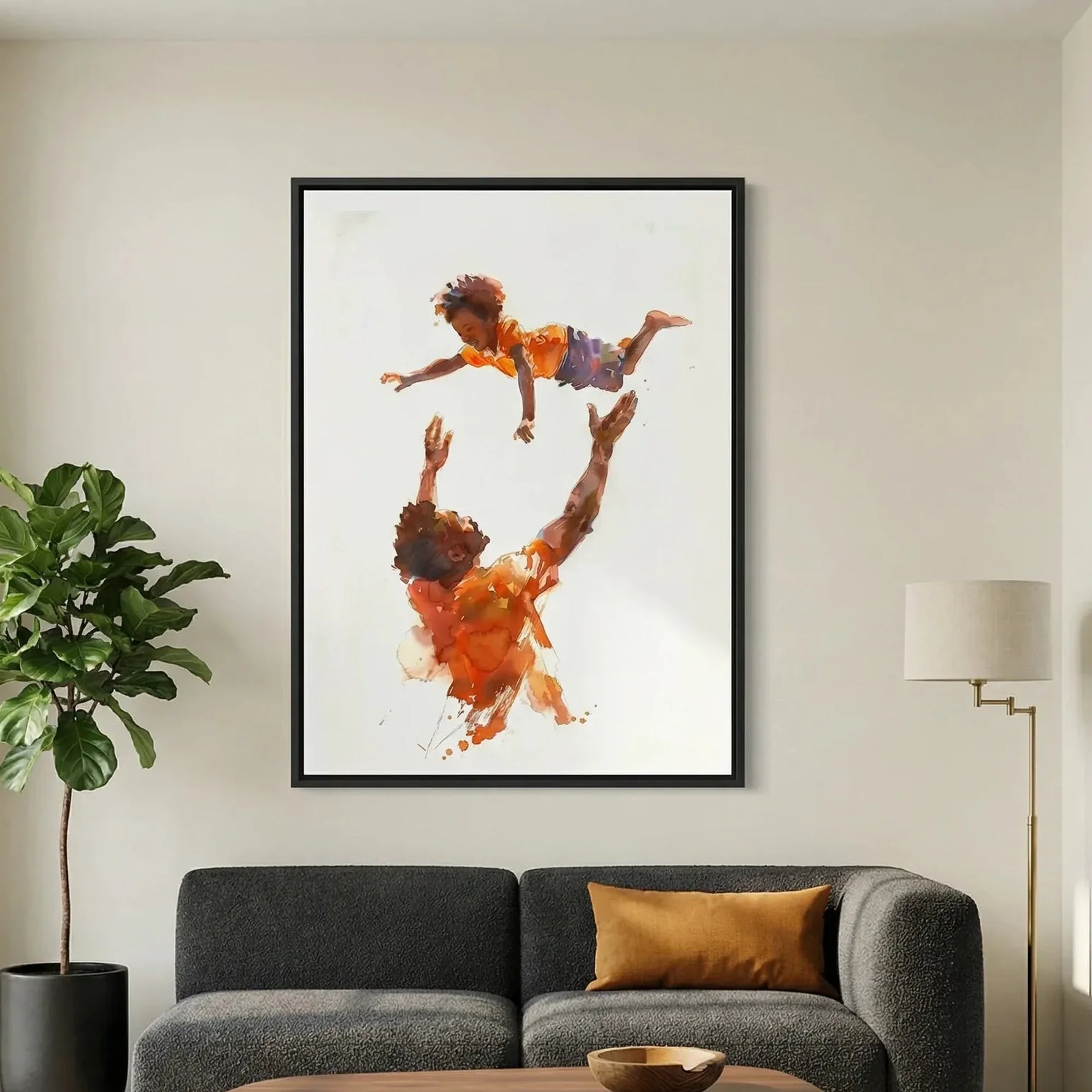 Modern African American art in modern living room with charcoal sofa and fiddle leaf, watercolor Black father tossing son. Digital mockup.