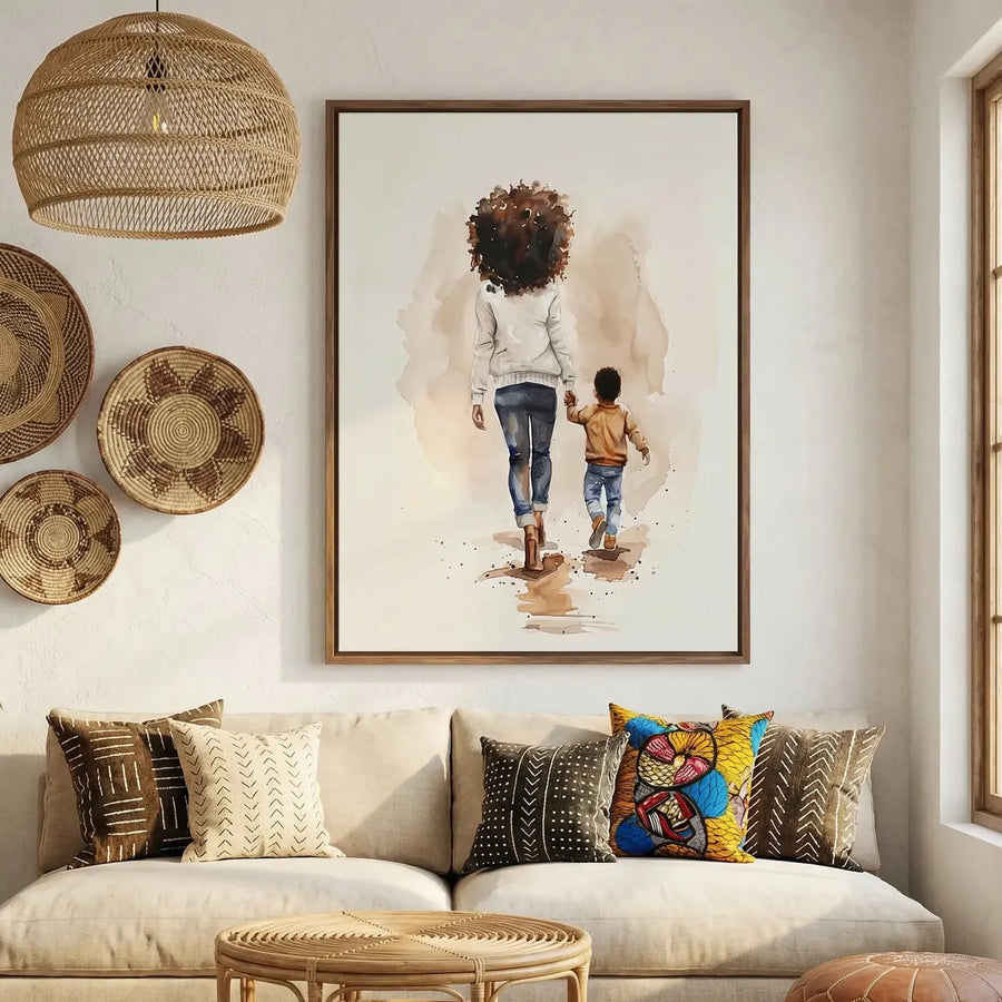 Afrohemian home decor wall art in boho Moroccan living room with mudcloth pillows, watercolor Black mother walking with son. Digital mockup.
