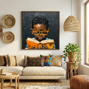 Afrohemian home decor wall art in boho Moroccan living room with mudcloth pillows, Black boy in orange glasses reading. Digital mockup.
