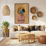 Afrohemian home decor wall art above boho cream sofa with mudcloth pillows, woven baskets, leather pouf. Digital mockup.