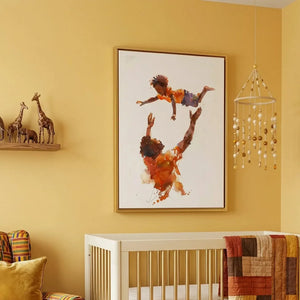 Black art for nursery walls in mustard nursery with white crib and kente armchair, watercolor Black father tossing son. Digital mockup.