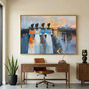 Modern Afro art for office in modern home office with walnut desk and leather chair, four Black women in flowing dresses. Digital mockup.