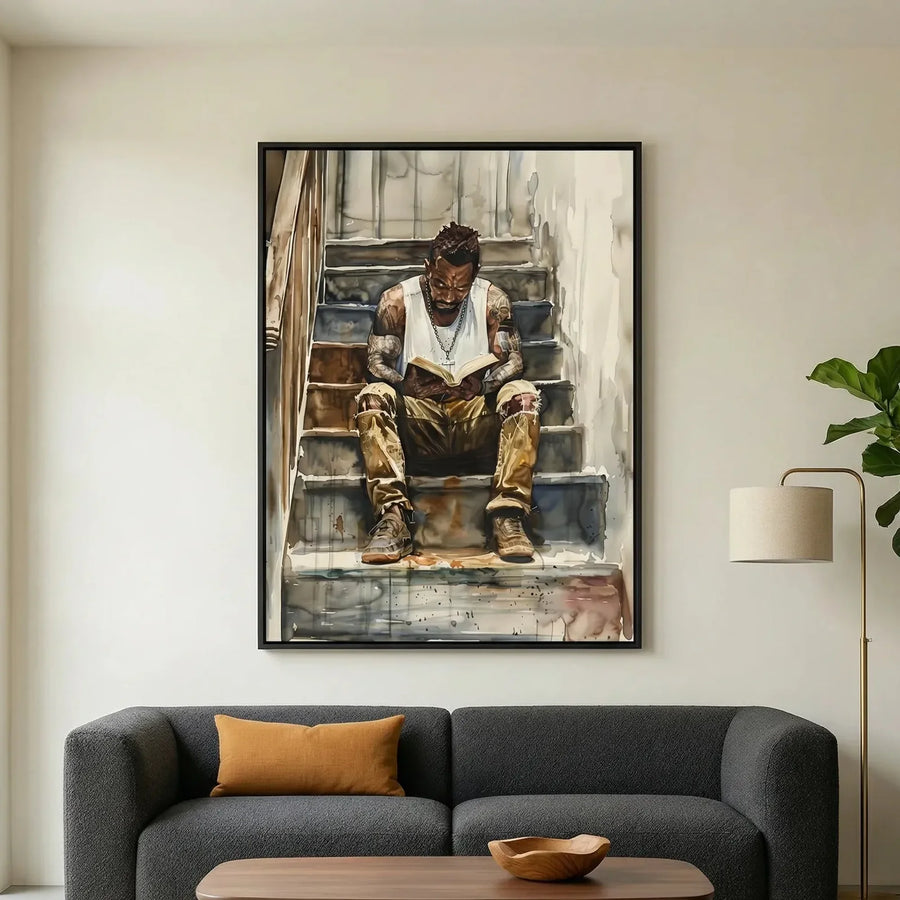 Black art for living room in modern living room with gray sofa and fiddle leaf, watercolor of Black man reading. Digital mockup.